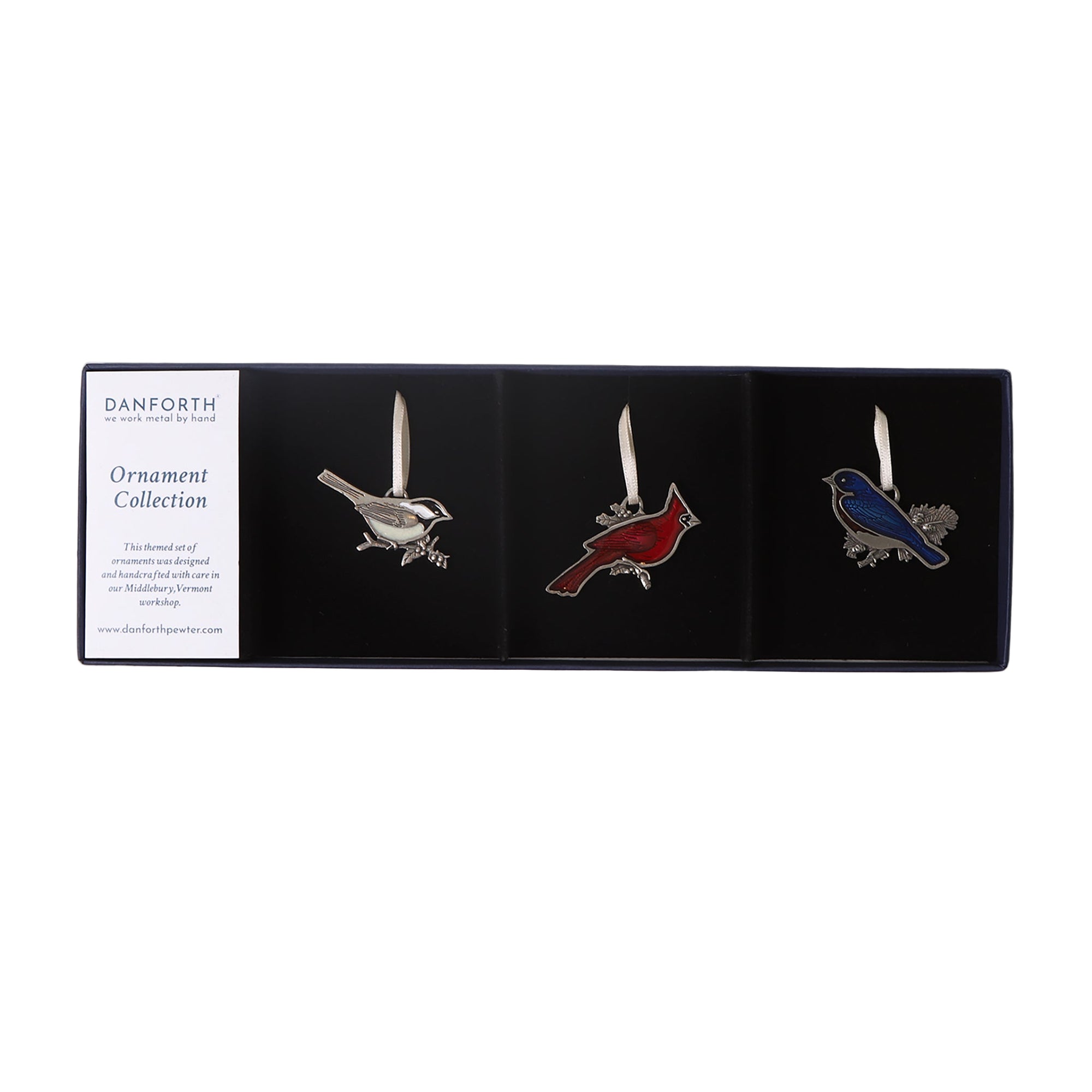Three bird-shaped ornaments on white background