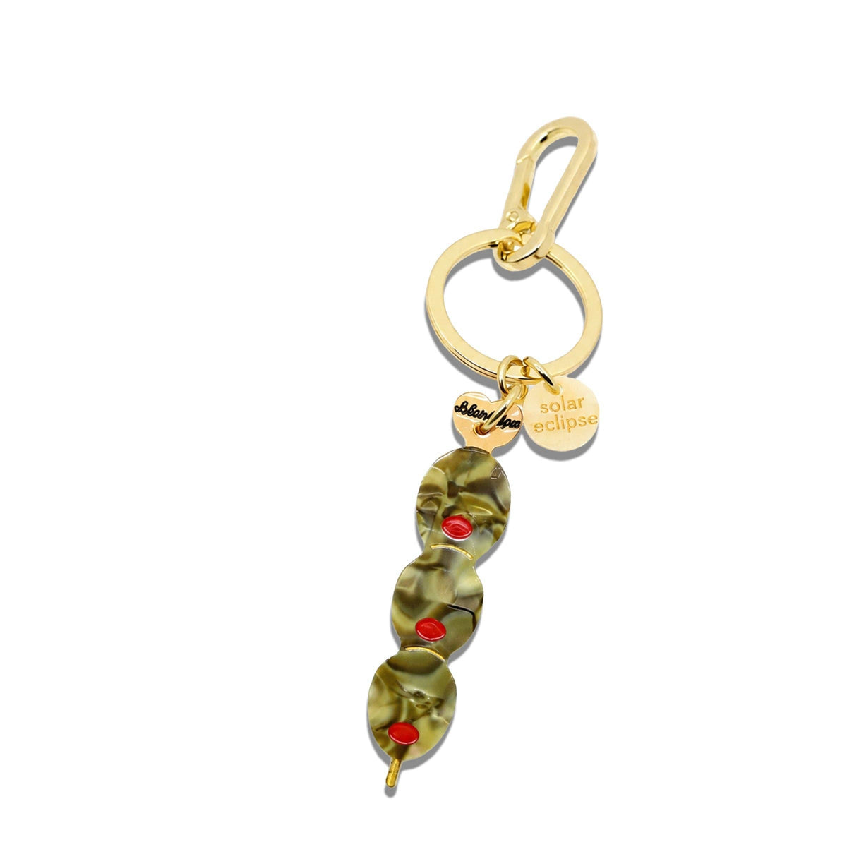 Gold keychain with green olives on a white background
