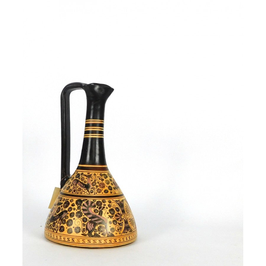 A ceramic Corinthian jug with a black handle and gold body, featuring intricate black patterns.