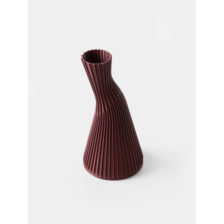 Maroon ribbed vase on a white background