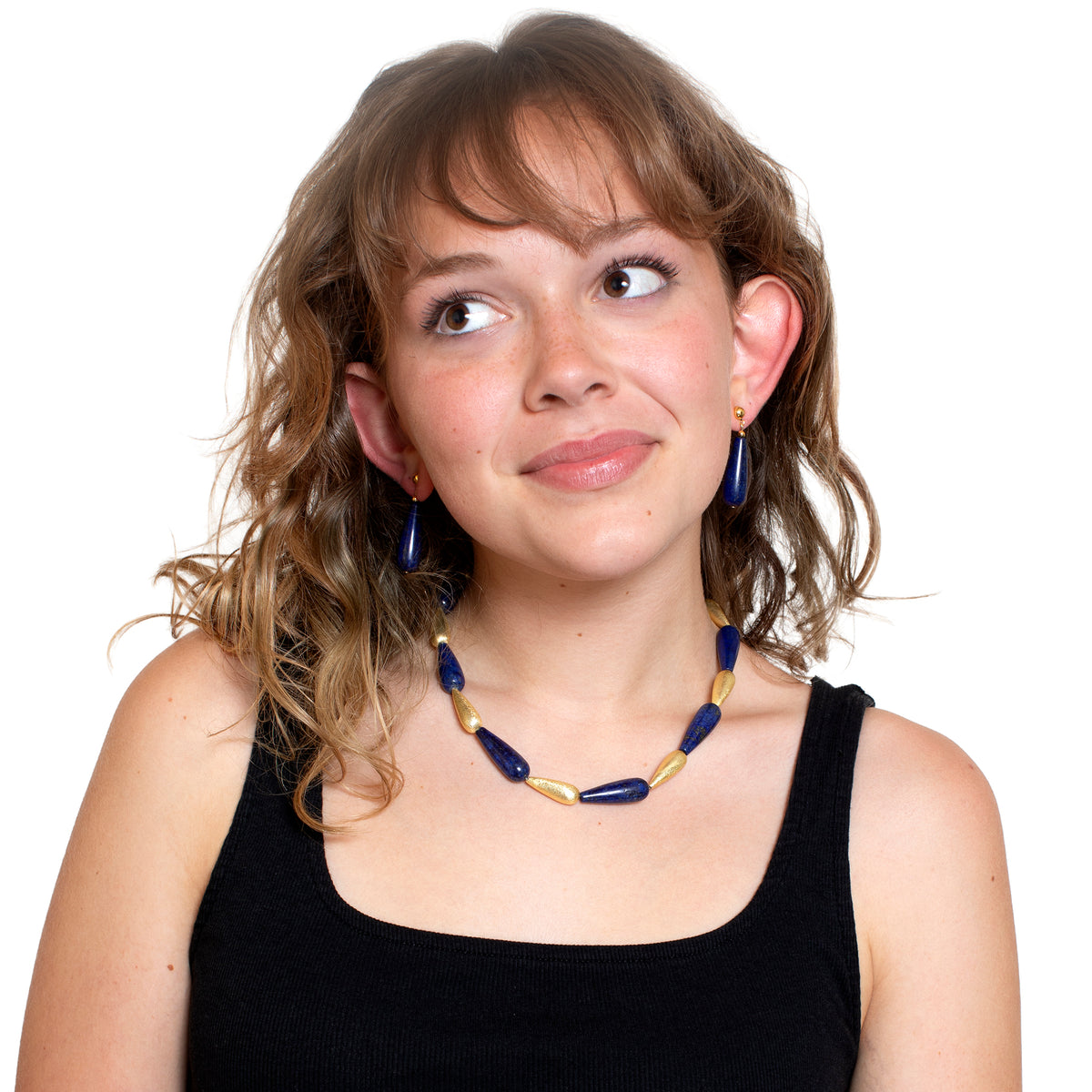 Woman wearing a blue and gold necklace on a white background