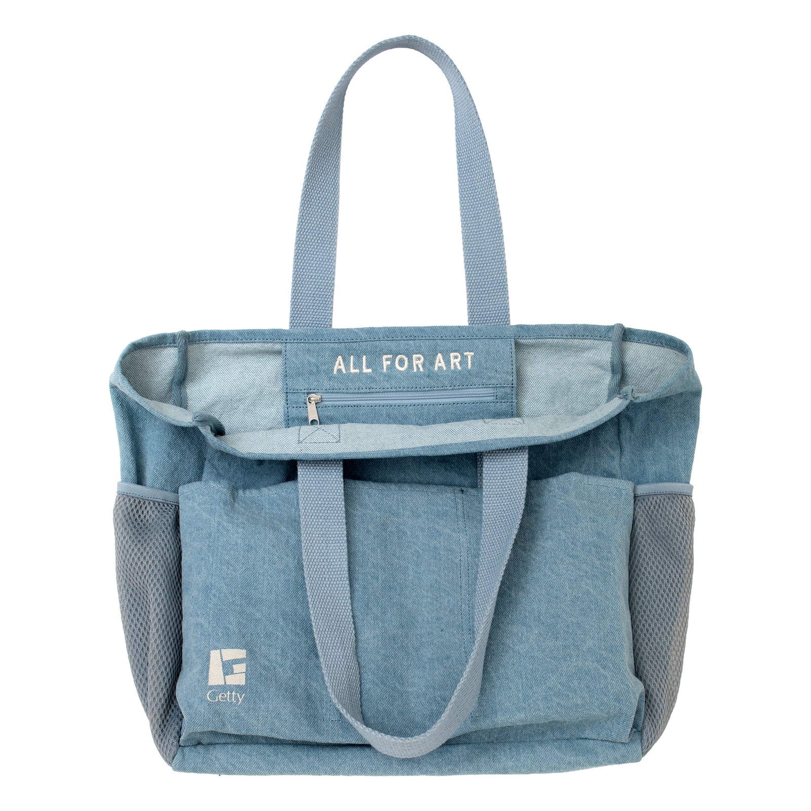 A light blue denim tote bag with mesh side pockets and matching handles, featuring a white 'Getty' logo on the lower left front pocket, set against a plain white background.