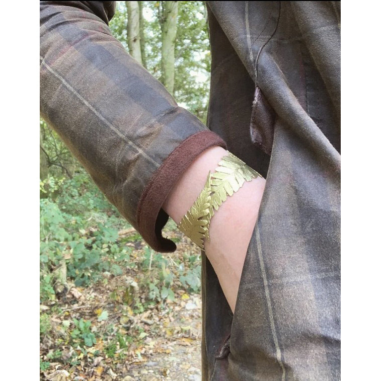 Person wearing a plaid coat with a forest background