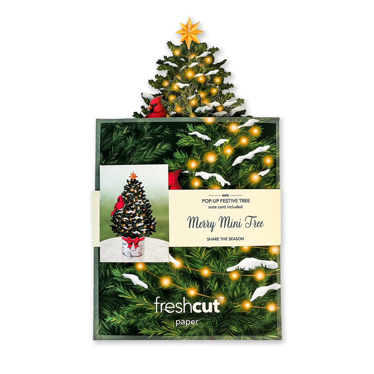 Christmas tree with lights and decorations on a white background, featuring &#39;freshcut paper&#39; branding.