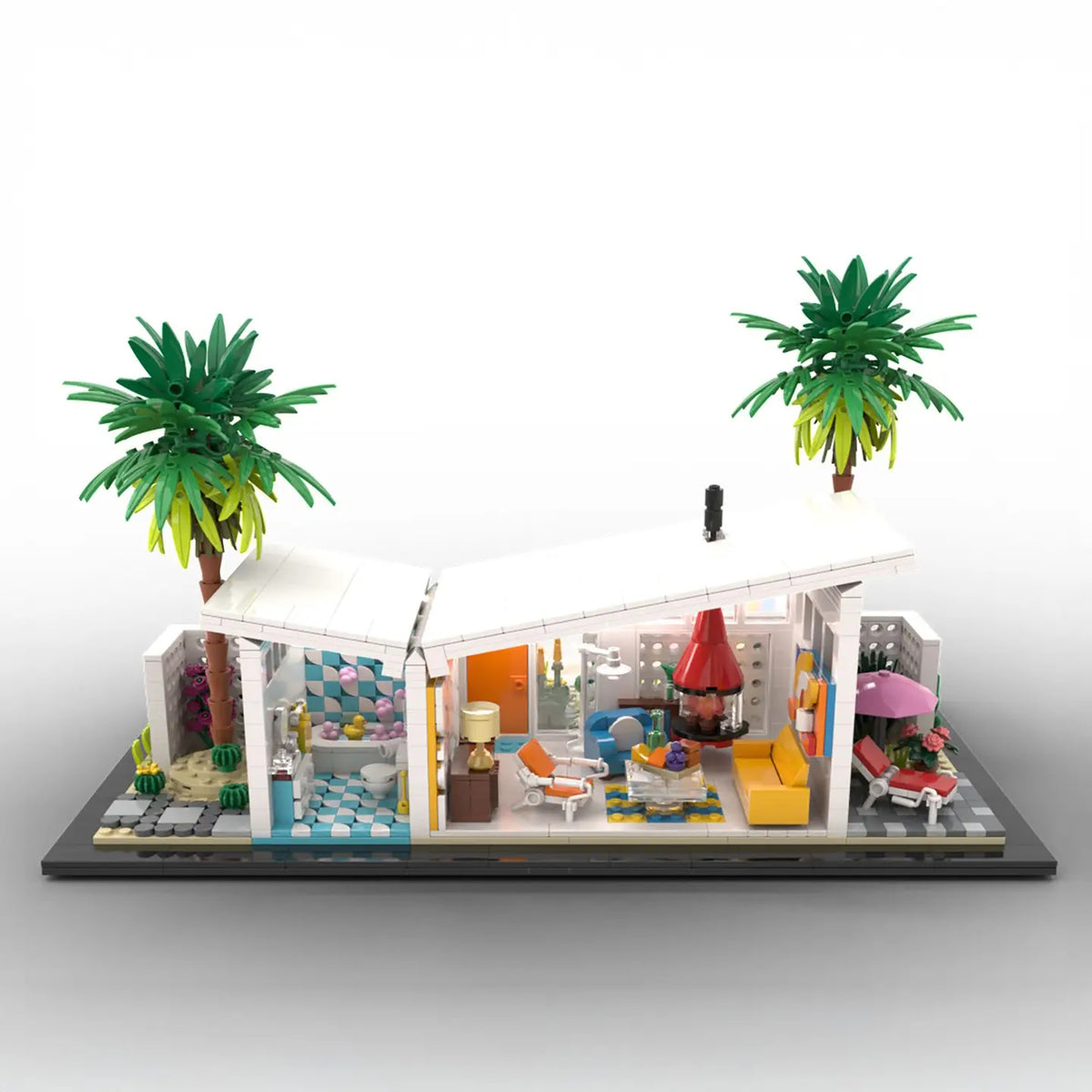 A detailed brick-built model of a modernist house with two palm trees, shown on a clean white background. The house features an open design with various colorful interior rooms, furniture, and a small pool area.