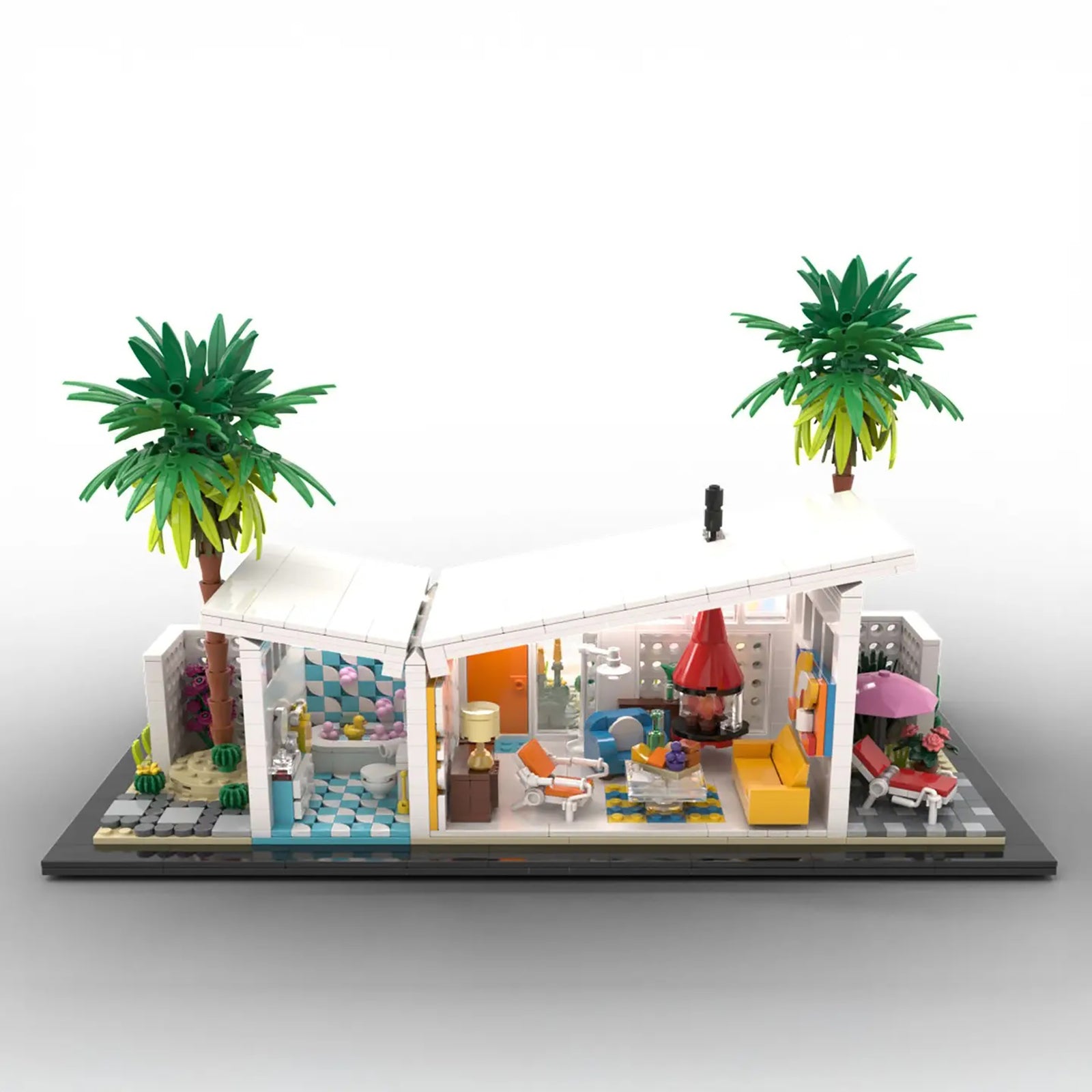 A detailed model of a mid-century modern house built from interlocking blocks, featuring two palm trees, cacti, and a landscaped garden on a white background.