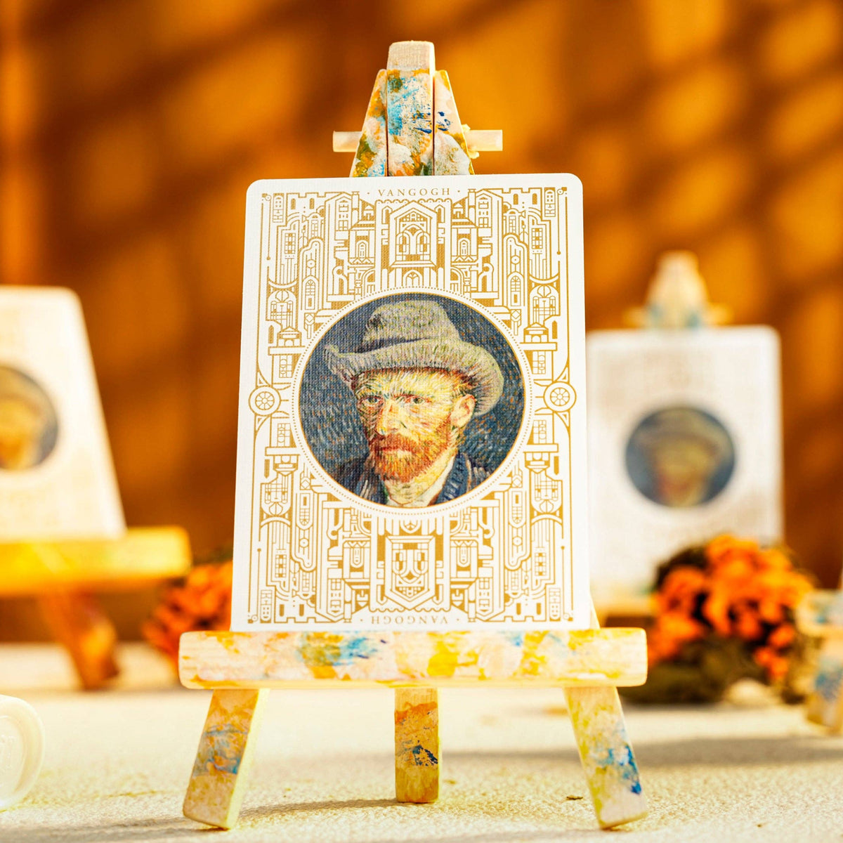 Decorative items with Van Gogh portrait on an easel against a blurred background