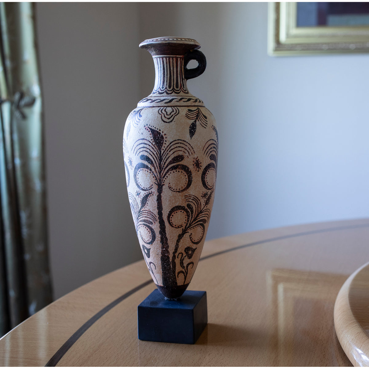 Decorative vase with intricate patterns on a wooden surface