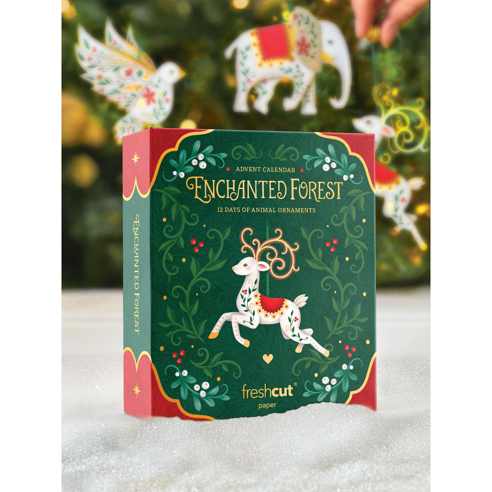 Enchanted Forest advent calendar packaging with Christmas ornaments in the background