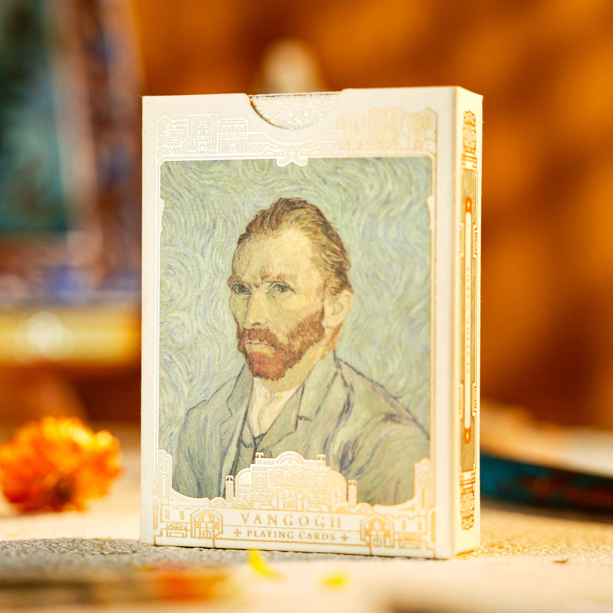 Small box with a portrait of a man on it, placed on a surface with a blurred background