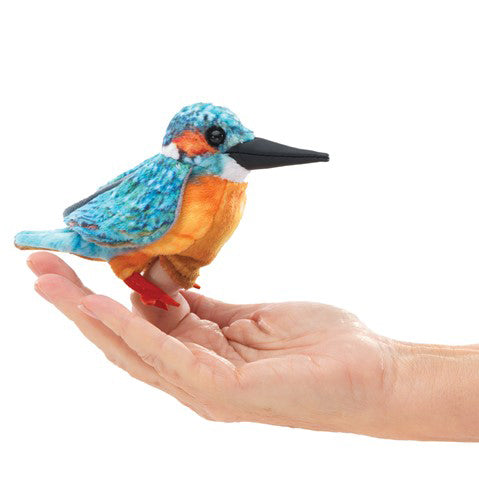Colorful bird plush toy held in a hand on a white background