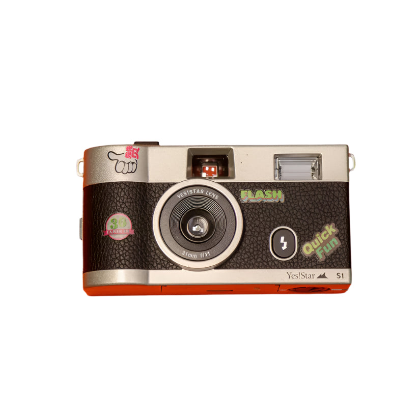 A compact 35mm film camera with a matte silver finish and black leatherette center, placed on an orange background.