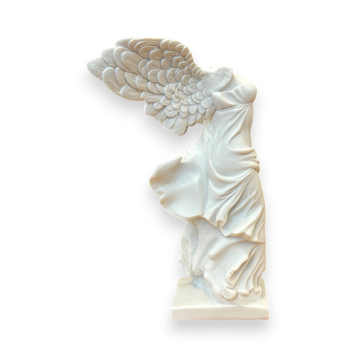 White sculpture of a draped figure with wings on a white background