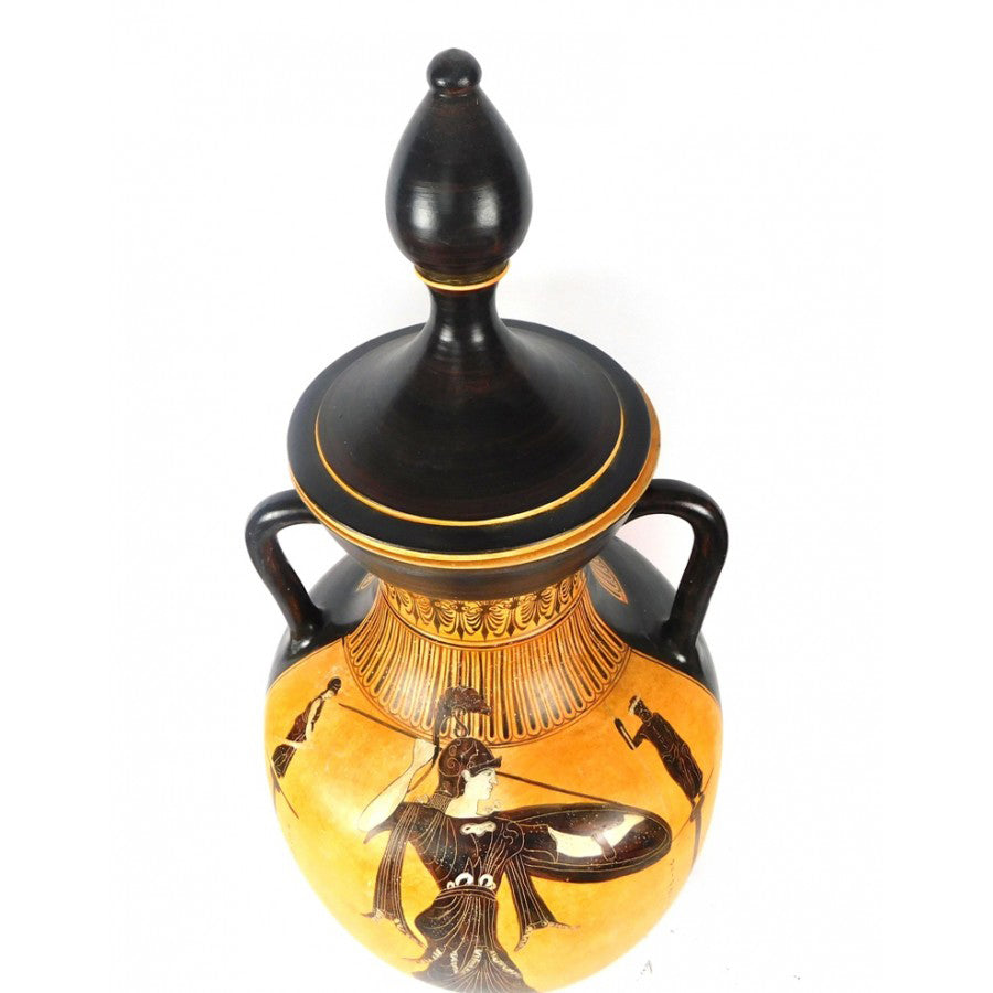 Decorative vase with black and gold design on a white background