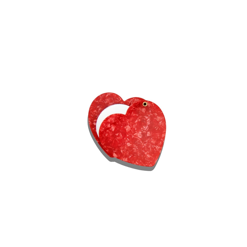 Red heart-shaped object on a white background