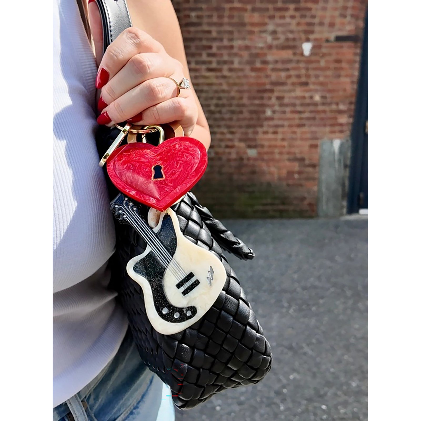 Red heart-shaped lock keychain with gold accents on a white background