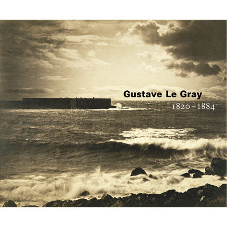 A sepia-toned artwork showing a rocky ocean shoreline with waves breaking, a dark fort or structure on the left, and cloudy sky above. Text on the right reads 'Gustave Le Gray' and '1820-1884'.