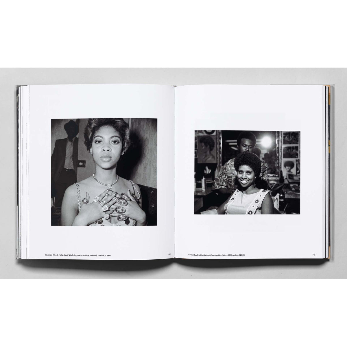 Open book showing black and white photographs of a woman with tattoos.