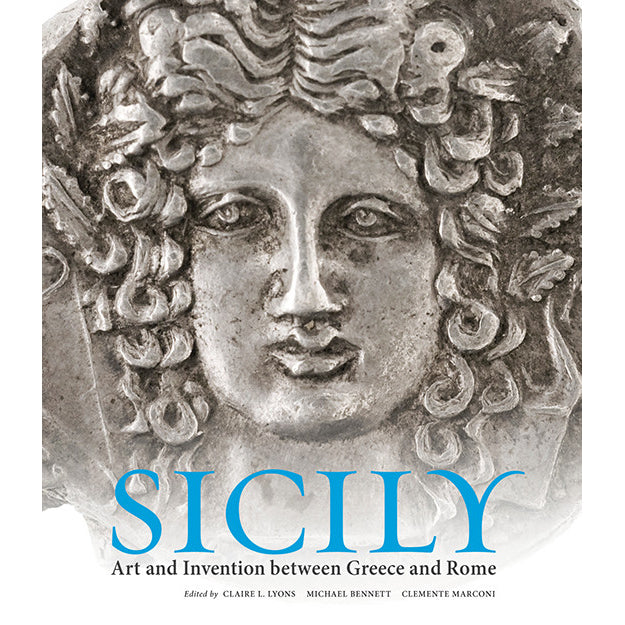 Book cover for 'SICILY Art and Invention between Greece and Rome', featuring a close-up photograph of a classical stone face with curly hair in grayscale, with the title 'SICILY' in large blue letters at the bottom.