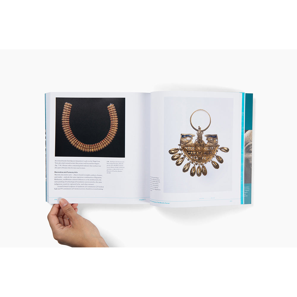 Open book with jewelry held open by a hand