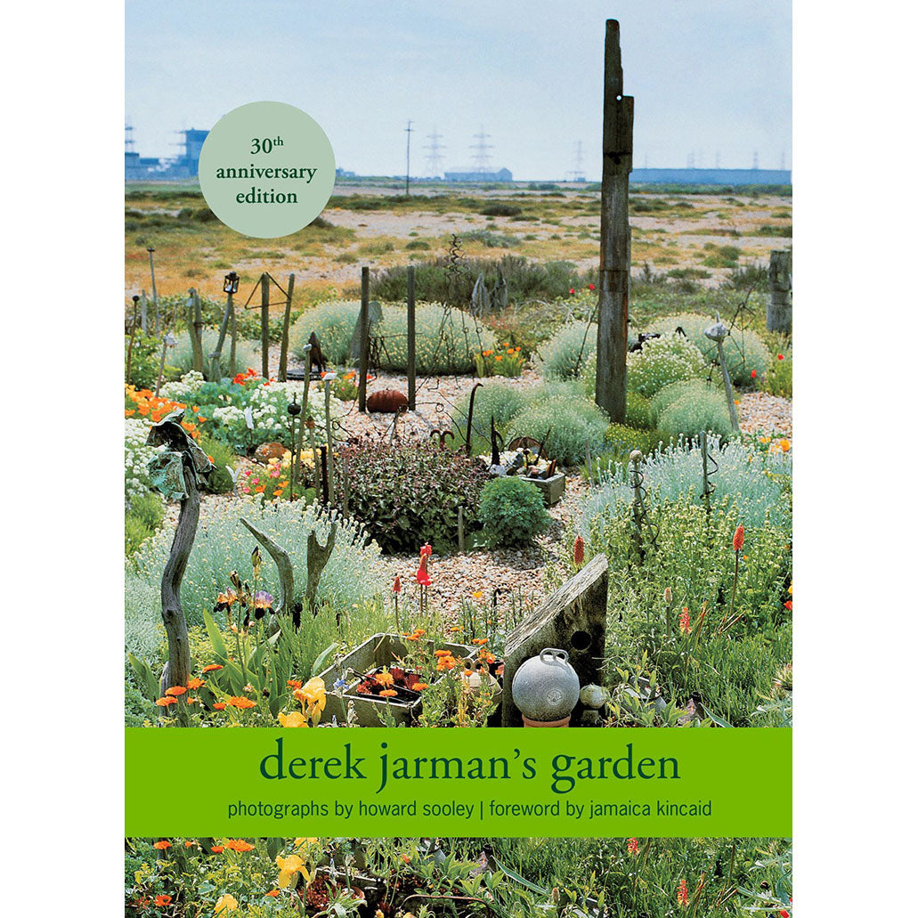 Cover of 'Derek Jarman's Garden: 30th Anniversary Edition' showing photographs by Howard Sooley of Derek Jarman's garden with a green band indicating the anniversary edition.