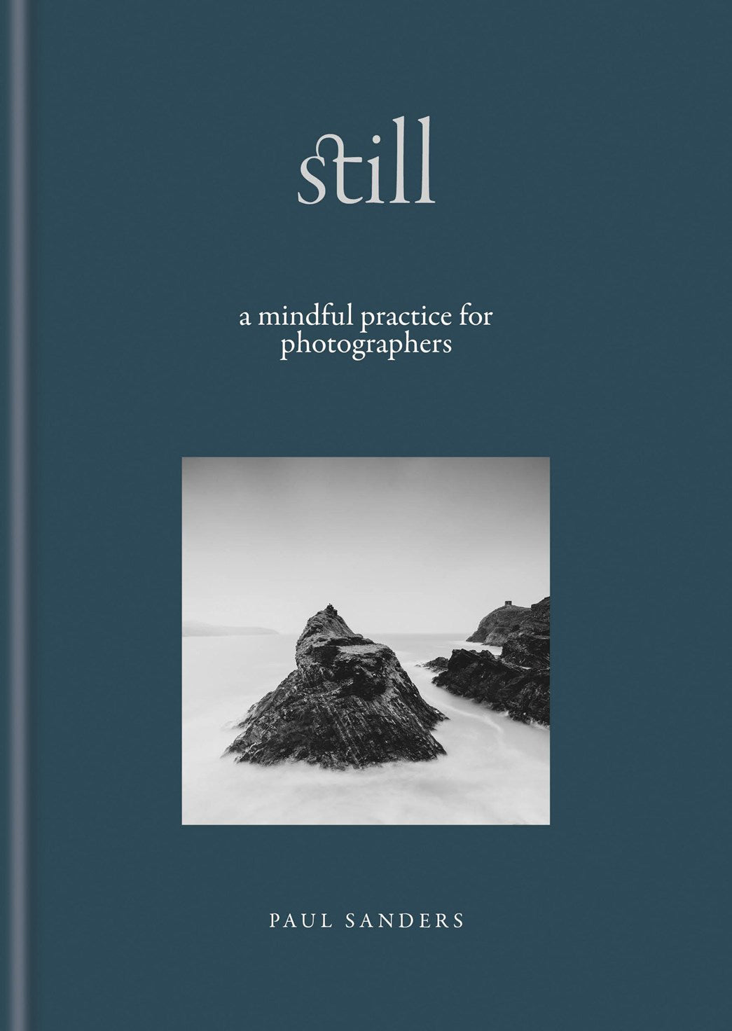 Book cover of 'Still: A Mindful Practice for Photographers' by Paul Sanders with a black and white photo of rocks on a beach.