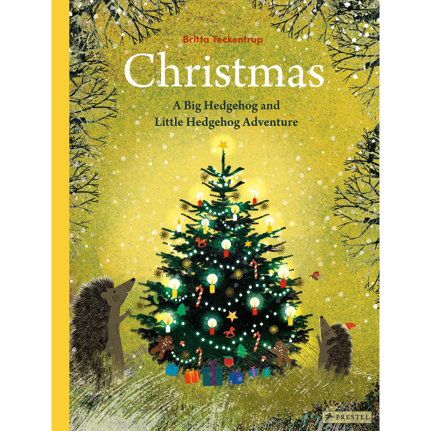 Book cover of 'Christmas: A Big Hedgehog and Little Hedgehog Adventure' by Brita Teckentrup, published by Prestel. The cover features a festive illustration of a decorated Christmas tree with glowing lights, gifts, and hedgehogs in a snowy winter scene, set against a golden-yellow background with bare tree branches at the top.