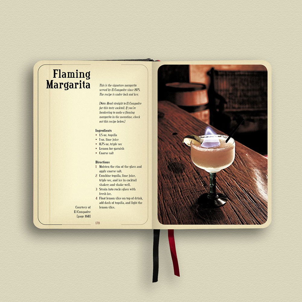Open book with a Flaming Margarita recipe and a photo of a cocktail on a wooden surface.
