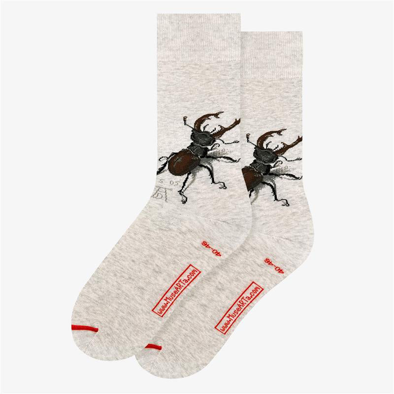 Gray socks with stag beetle design and red branding on a white background