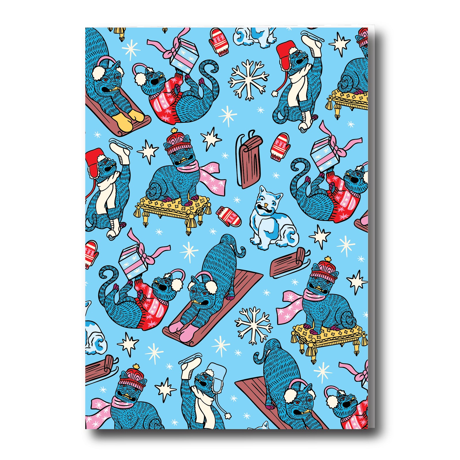 Patterned paper with cartoon cats in winter attire on a blue background