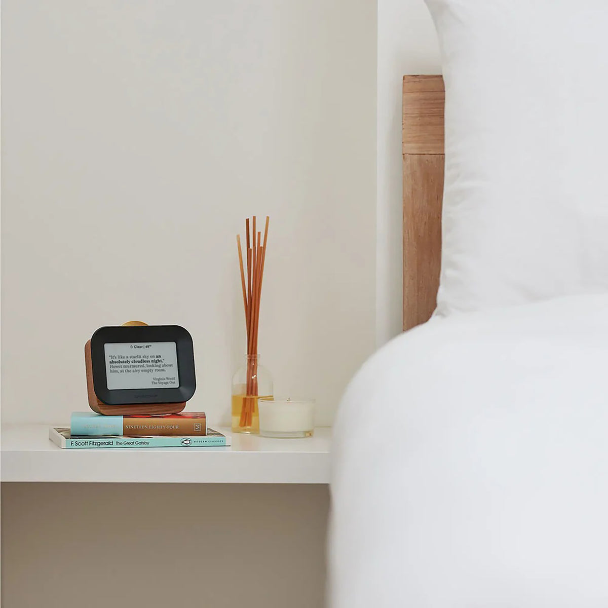 Smart home device on a nightstand next to a bed