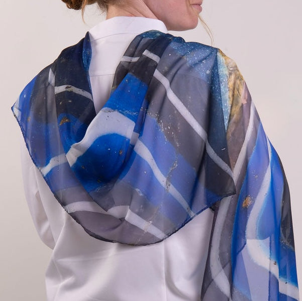 Blue and gray patterned scarf on a white background