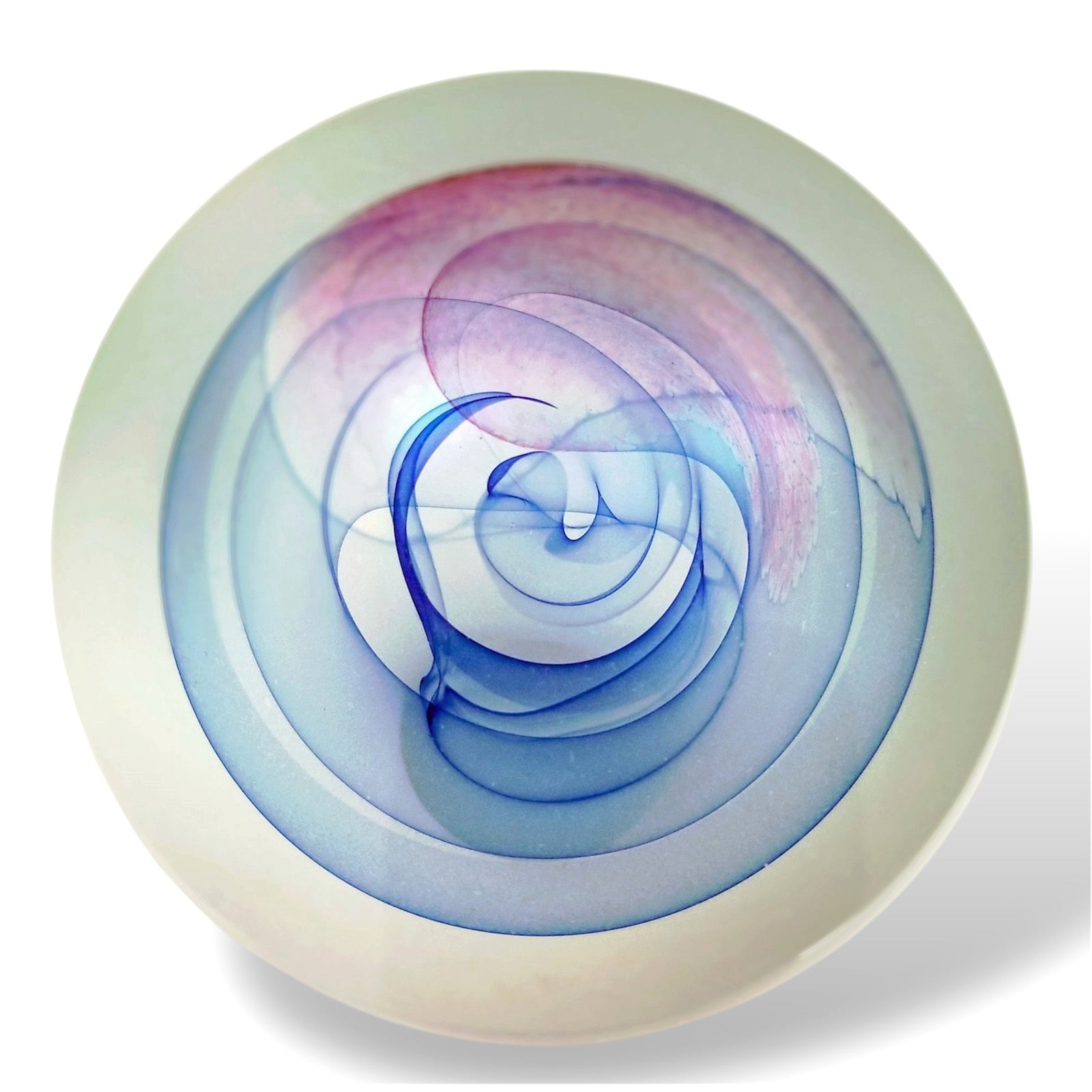 A round glass paperweight with blue and rose swirls, and a mother of pearl exterior.