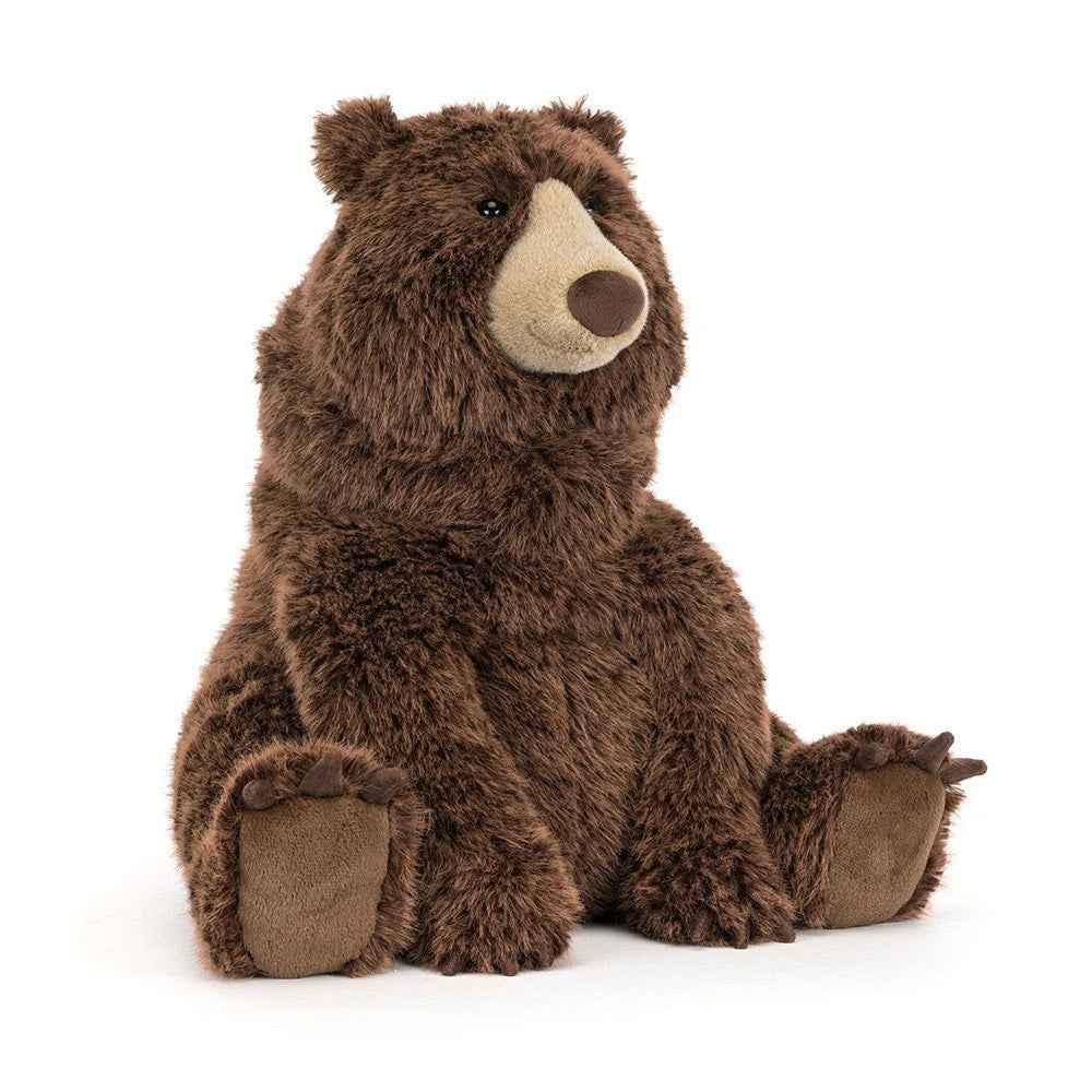 A brown plush stuffed bear toy sitting upright on a clean white background.
