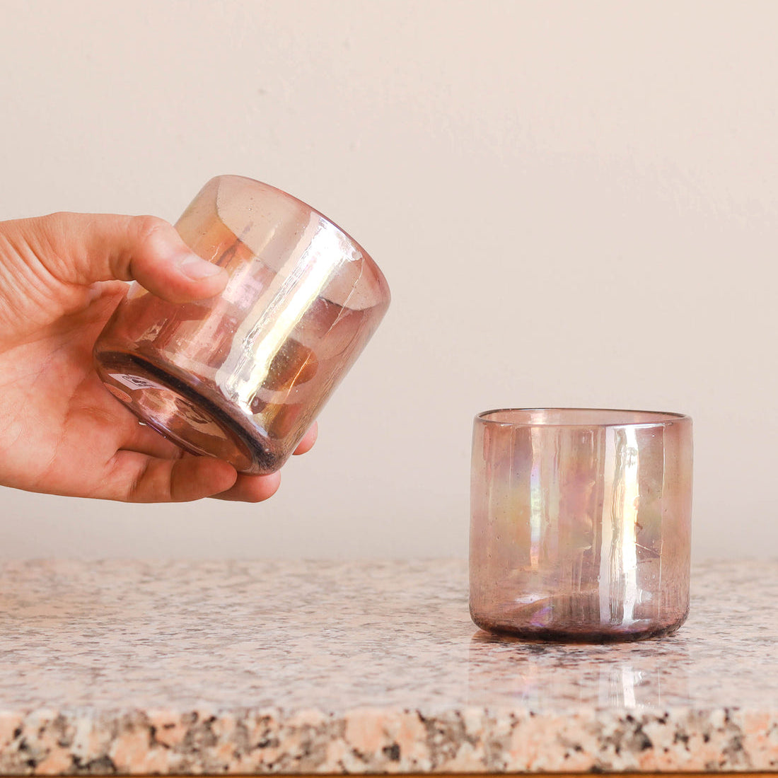 Person holding a cup in their hand