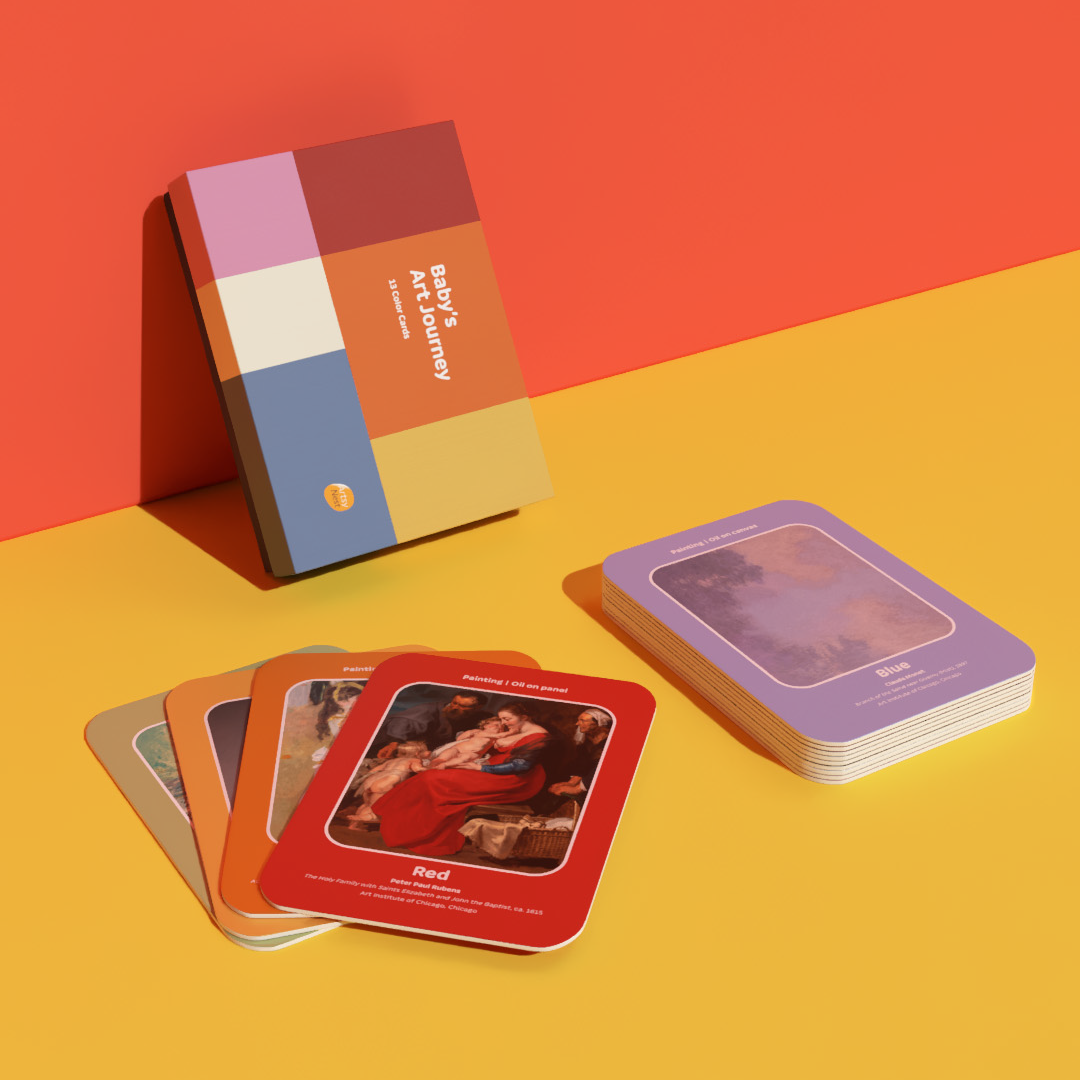 A boxed card deck titled 'The Book Journey' stands upright next to several fanned-out cards and a stack of cards on a bright yellow surface against a coral-orange background.