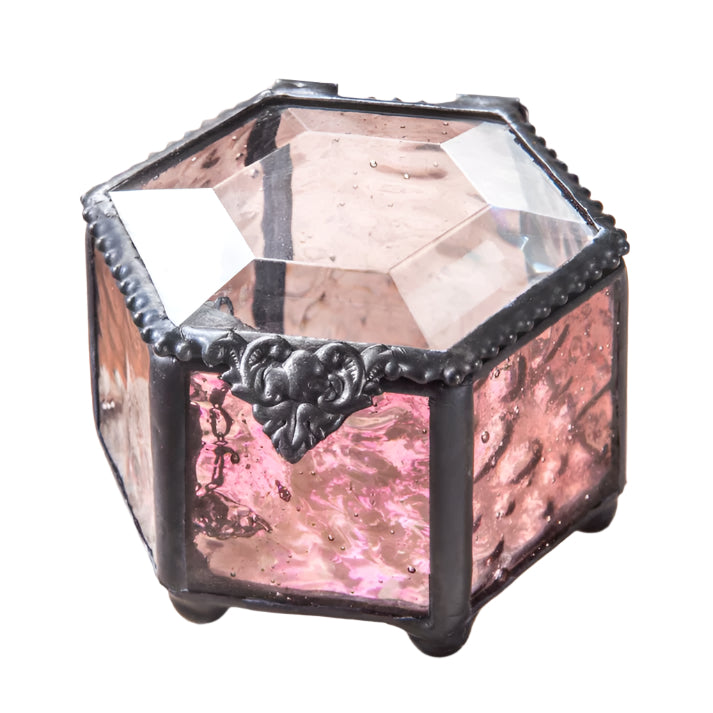 Decorative pink glass box with metal hardware in the shape of a hexagon