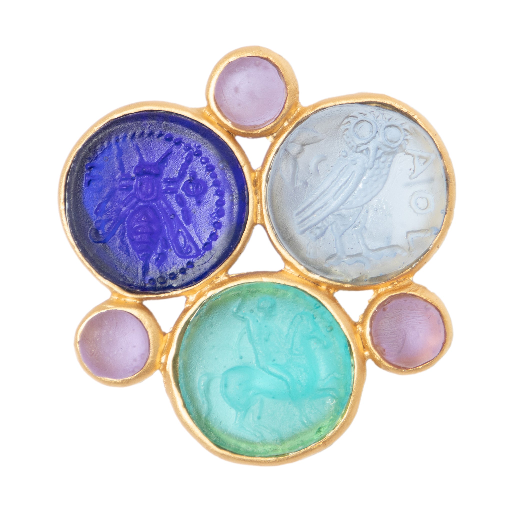 A glass multi-coin brooch with vibrant blue, green, and purple colors, featuring intricate embossed designs resembling coins, surrounded by a gold-tone metal frame.