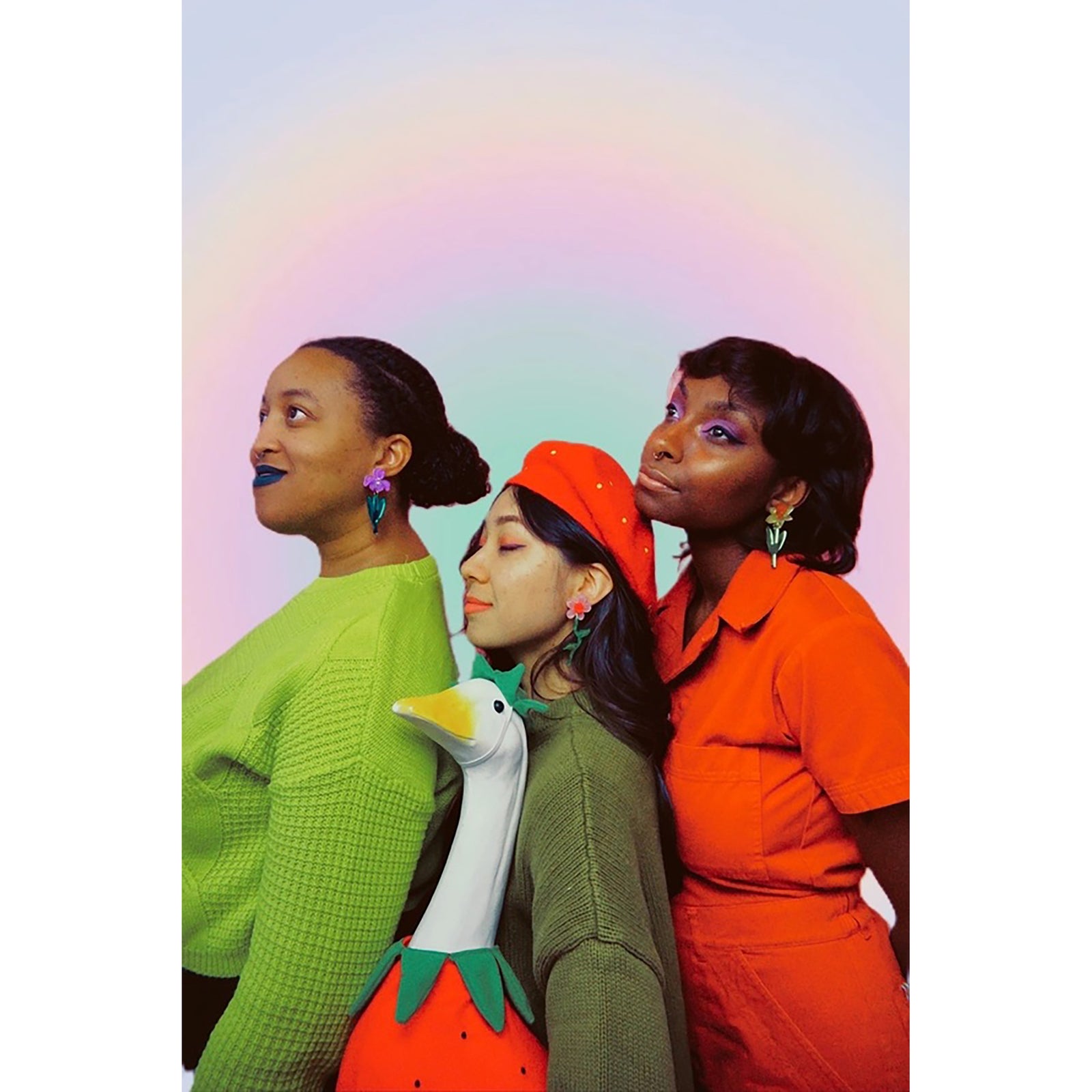 Purple flower-shaped earrings with blue leaves on a light surface.