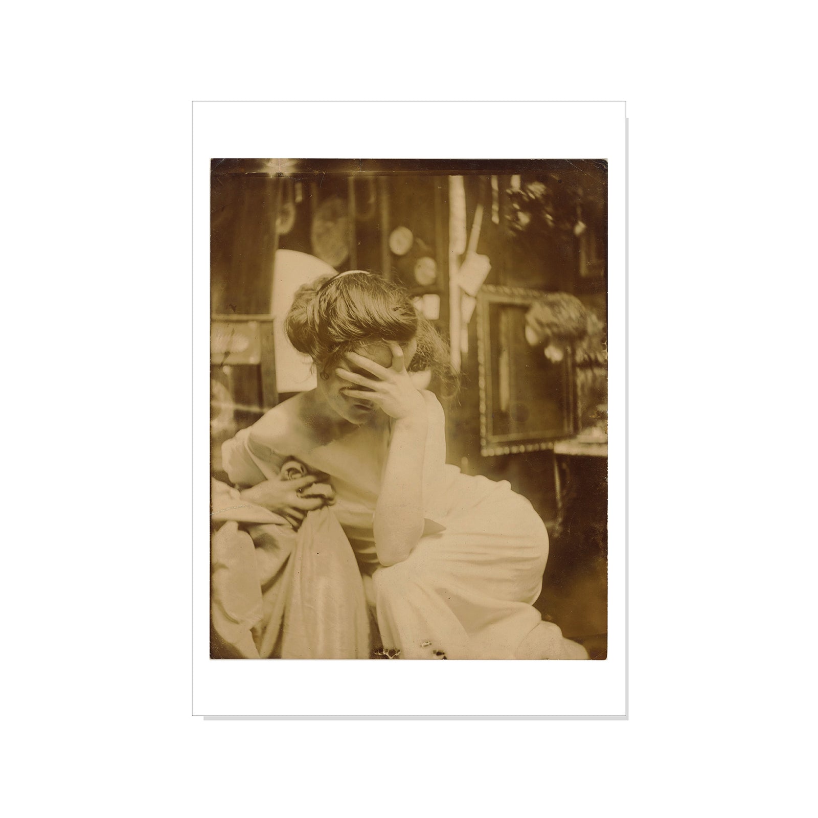 Vintage sepia-toned photograph of a woman sitting with her hand on her face.