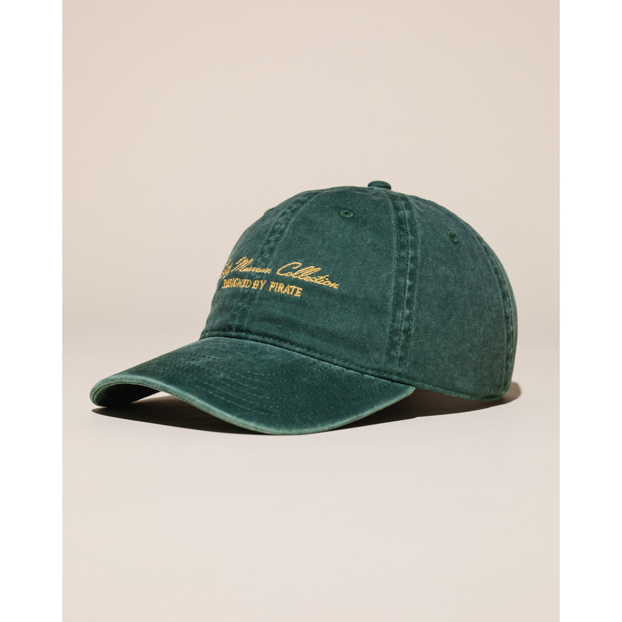 Green cap with embroidered text on a white background