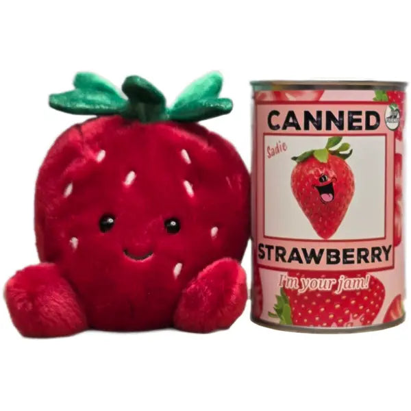 Plush strawberry toy next to a can of 'Canned Strawberry' with a cartoon strawberry on the label.