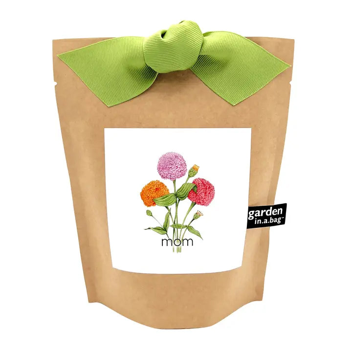 Kraft paper gift bag with colorful flowers and a green bow on a white background