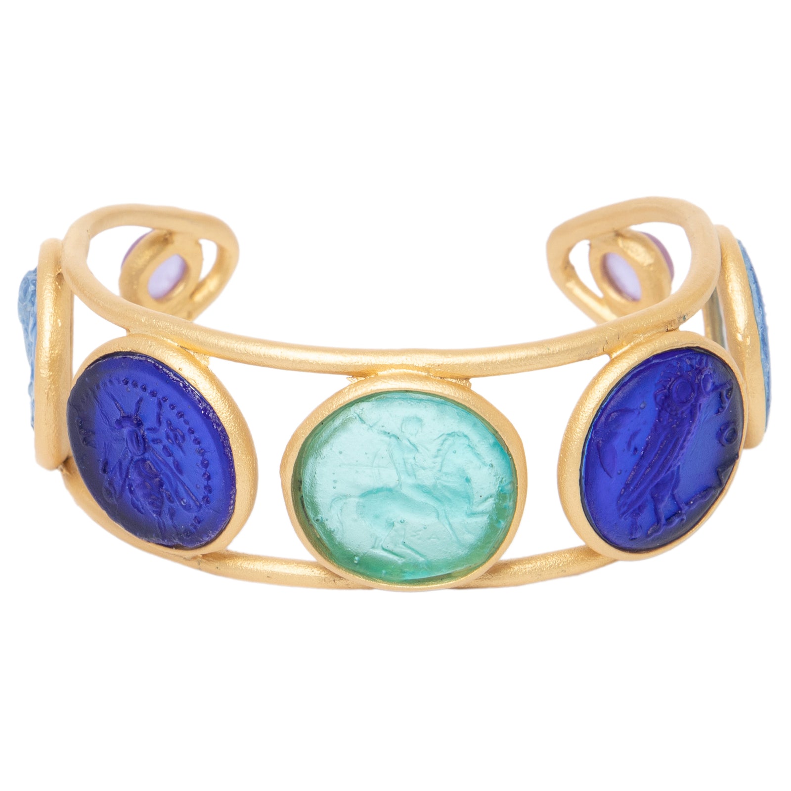 A gold-colored metal cuff bracelet with circular glass coin-like embellishments in blue and green shades.