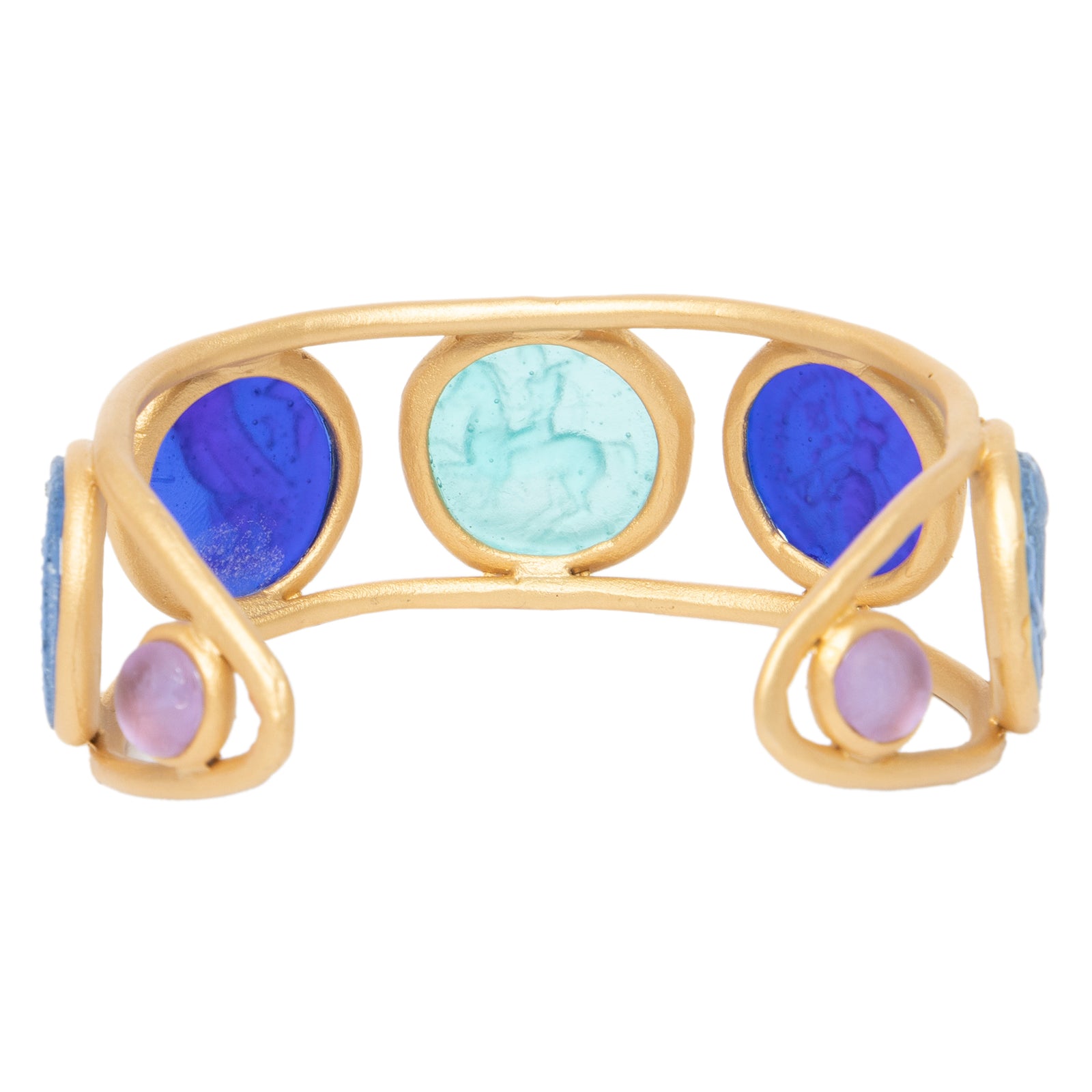 A gold-colored metal cuff bracelet with circular glass coin-like embellishments in blue and green shades.