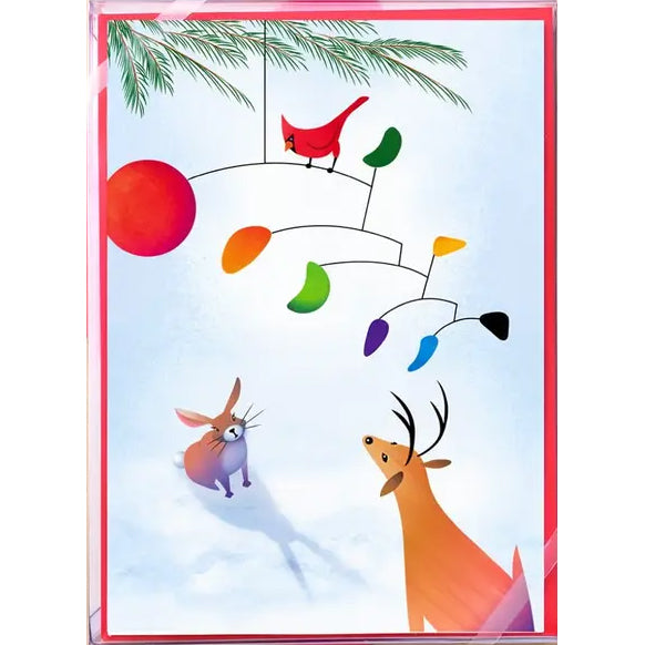 A square greeting card or art print featuring whimsical winter illustrations: a red cardinal perched under a multicolored mobile, a red sun, pine branches, a rabbit, and a deer on a pale blue snowy background with a pink border.