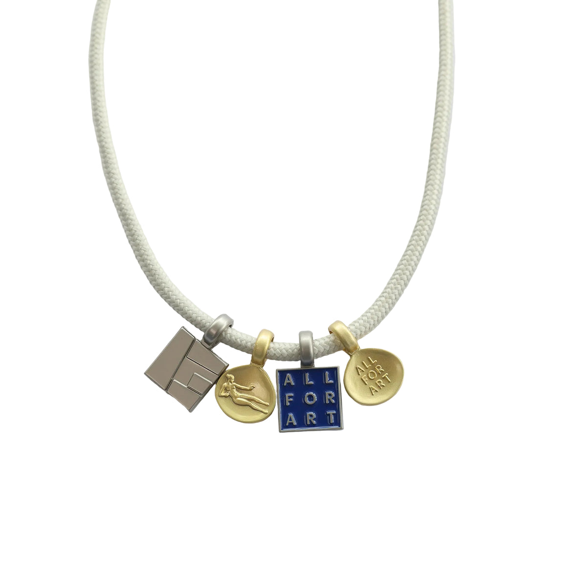 A cream-colored braided cord necklace with four small charms: a silver-toned geometric block, a gold-toned circular charm with a figure, a blue and silver-toned square charm reading 'ALL FOR ART', and a gold-toned circular charm with 'LOVE ART' text.