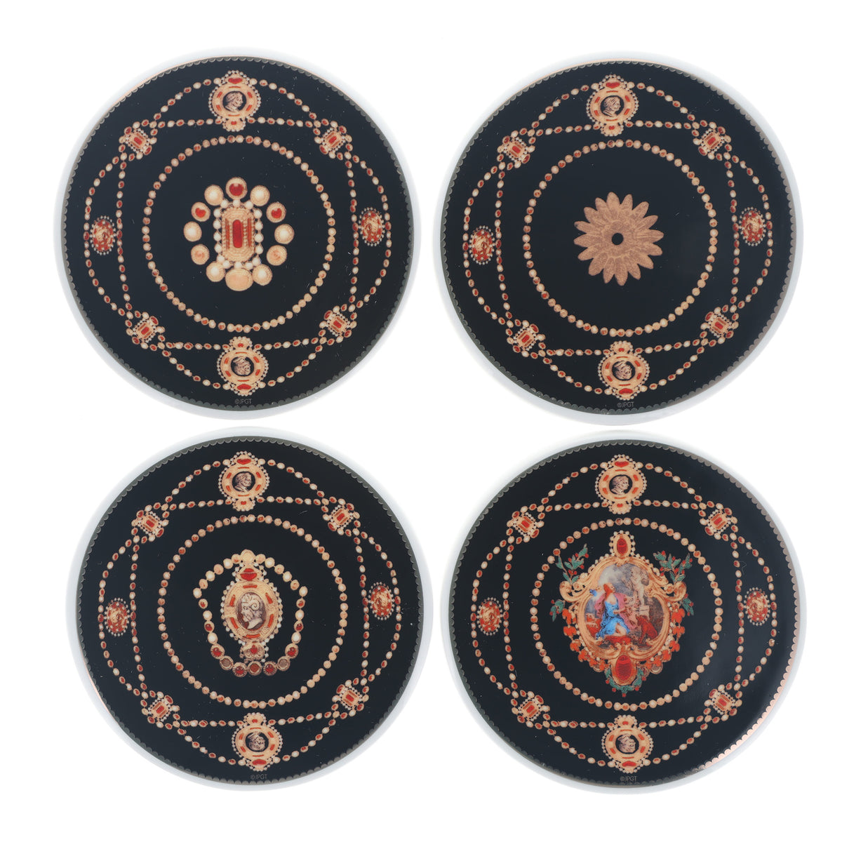 Four round black decorative coasters with intricate gold, red, and white printed mandala and floral designs, arranged in a 2x2 grid on a white background.