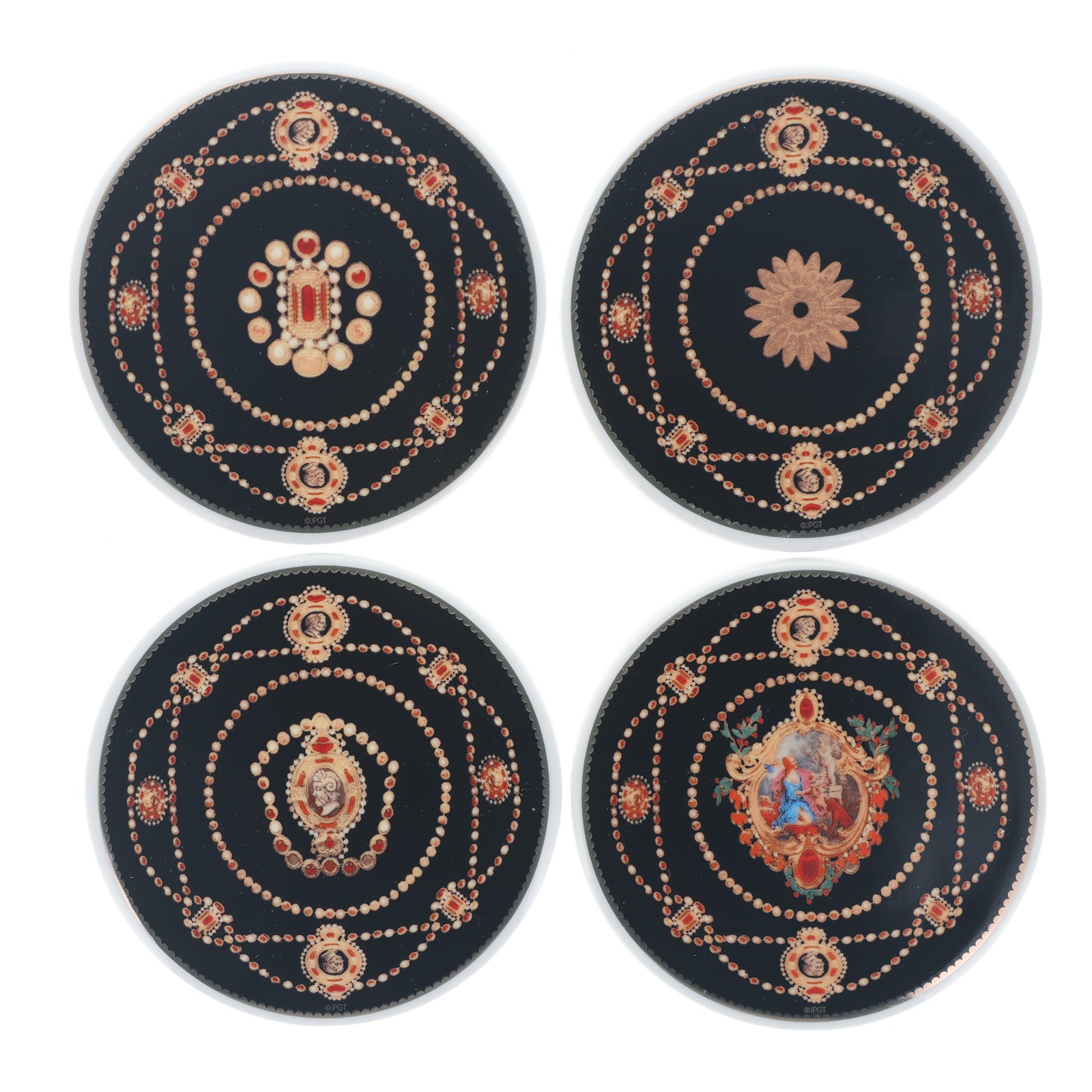 Four round black decorative coasters with intricate gold, red, and white printed mandala and floral designs, arranged in a 2x2 grid on a white background.
