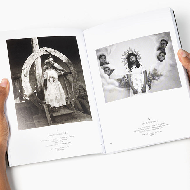 An open hardcover book or art print showing two black-and-white photographic pages held by hands against a clean white background.